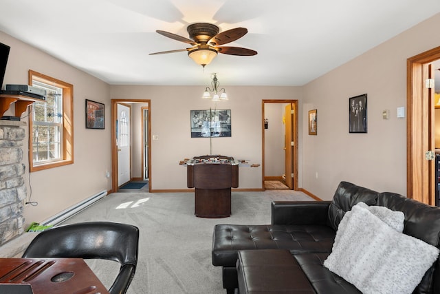 living area featuring carpet, a ceiling fan, baseboards, and a baseboard radiator