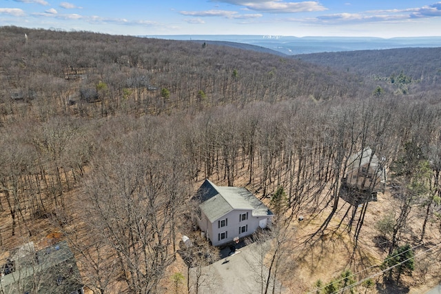 drone / aerial view with a wooded view