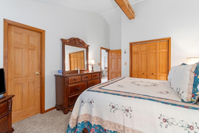 carpeted bedroom with beamed ceiling, a closet, high vaulted ceiling, and baseboards