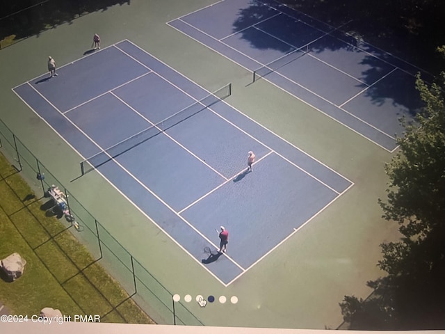 view of tennis court with fence