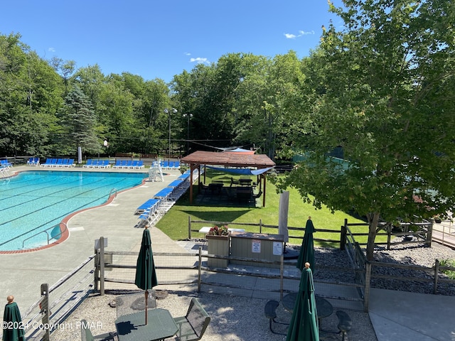 pool with a yard, a patio area, and fence