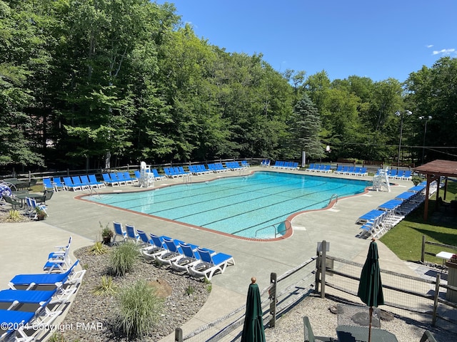 community pool featuring a patio area and fence