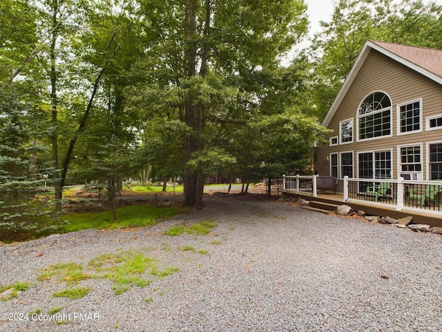 view of front of property featuring a deck and driveway