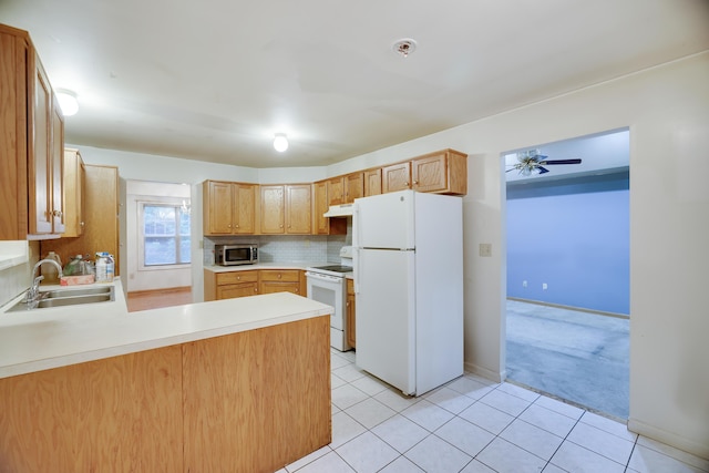 3122 Sparrow Ct, East Stroudsburg, PA 18302 - kitchen featuring white appliances, under cabinet range hood, a peninsula, light countertops, and backsplash