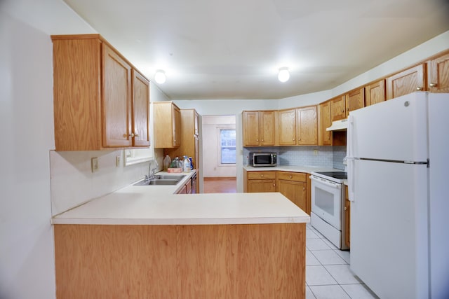 3122 Sparrow Ct, East Stroudsburg, PA 18302 - kitchen featuring white appliances, under cabinet range hood, light countertops, a peninsula, and backsplash