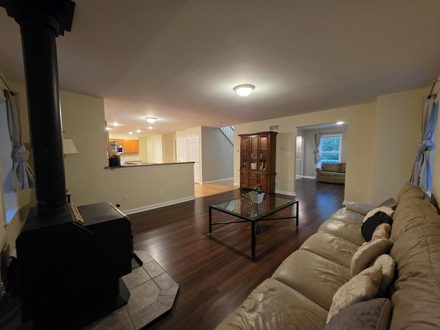 210 Grouse Run, Cresco, PA 18326 - living room featuring a wood stove, wood finished floors, and stairway