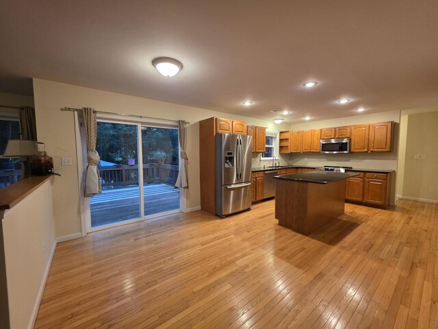 210 Grouse Run, Cresco, PA 18326 - kitchen with stainless steel appliances, dark countertops, light wood finished floors, recessed lighting, and brown cabinetry
