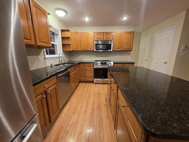 210 Grouse Run, Cresco, PA 18326 - kitchen with appliances with stainless steel finishes, light wood-style floors, open shelves, dark stone countertops, and brown cabinetry