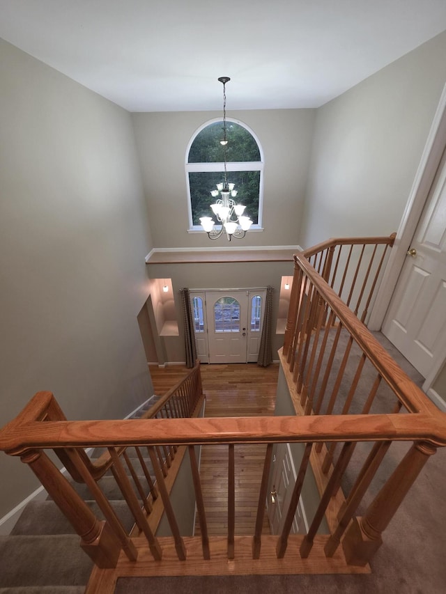 210 Grouse Run, Cresco, PA 18326 - foyer entrance featuring stairs, a chandelier, wood finished floors, and a towering ceiling
