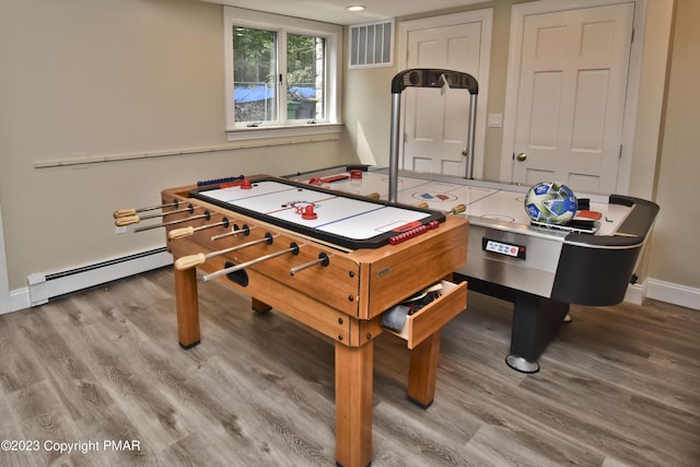 386 Camelback Rd, Tannersville, PA 18372 - rec room with visible vents, a baseboard radiator, wood finished floors, and baseboards
