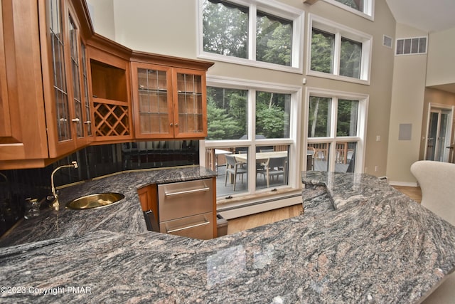 386 Camelback Rd, Tannersville, PA 18372 - kitchen with brown cabinetry, high vaulted ceiling, and visible vents