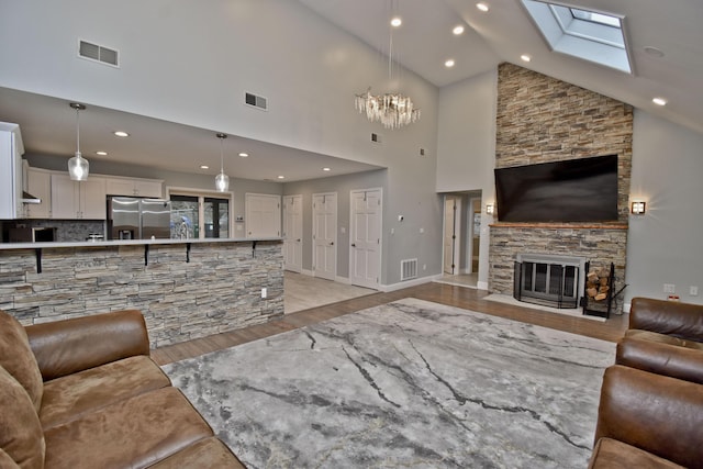 386 Camelback Rd, Tannersville, PA 18372 - living room featuring light wood-type flooring, high vaulted ceiling, and visible vents