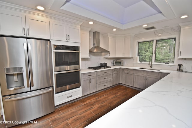 386 Camelback Rd, Tannersville, PA 18372 - kitchen with wall chimney range hood, visible vents, a sink, stainless steel appliances, and a raised ceiling