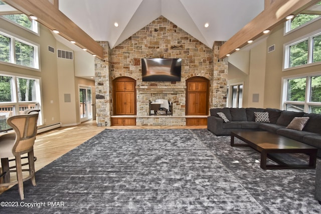386 Camelback Rd, Tannersville, PA 18372 - living area featuring high vaulted ceiling, light wood finished floors, visible vents, and a baseboard radiator