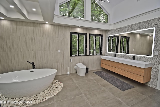 386 Camelback Rd, Tannersville, PA 18372 - full bathroom with concrete floors, a freestanding tub, toilet, double vanity, and recessed lighting