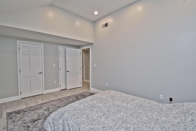 386 Camelback Rd, Tannersville, PA 18372 - bedroom with visible vents, baseboards, vaulted ceiling, and wood finished floors
