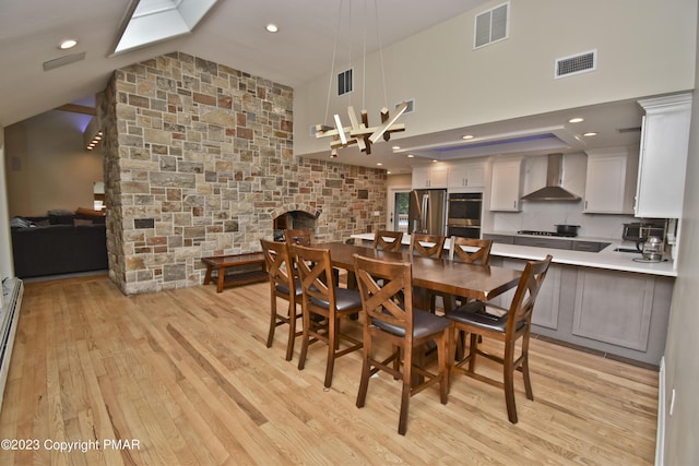 386 Camelback Rd, Tannersville, PA 18372 - dining area with visible vents, vaulted ceiling, and light wood-style floors