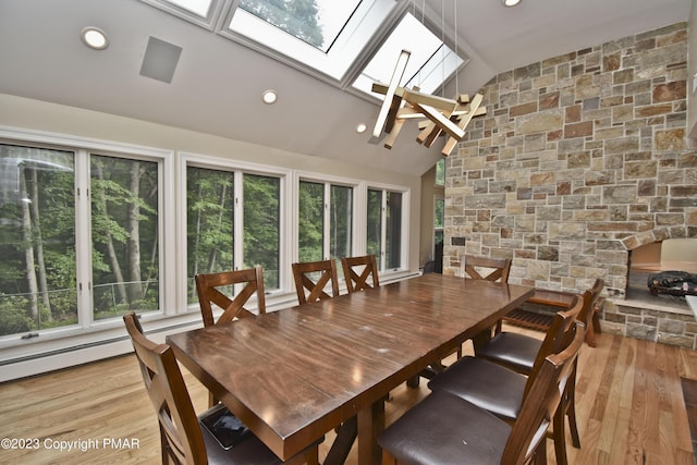 386 Camelback Rd, Tannersville, PA 18372 - dining area with vaulted ceiling with skylight, a healthy amount of sunlight, light wood finished floors, and recessed lighting