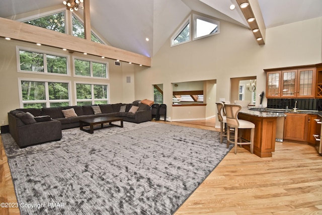 386 Camelback Rd, Tannersville, PA 18372 - living room featuring light wood finished floors, high vaulted ceiling, baseboards, and a wealth of natural light