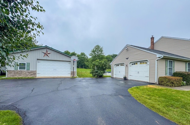 3708 Bayberry Dr, Danielsville, PA 18038 - view of side of home featuring board and batten siding, a yard, a chimney, and stone siding
