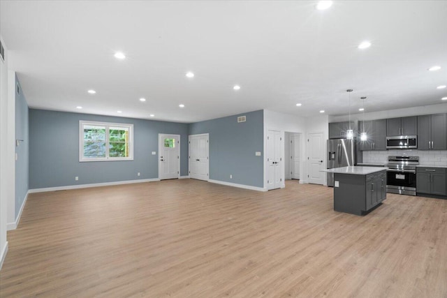 156 Crabapple Ln, Kunkletown, PA 18058 - kitchen featuring appliances with stainless steel finishes, open floor plan, a center island, light countertops, and backsplash