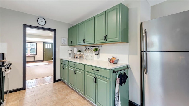 109 Silver Ln, Cresco, PA 18326 - kitchen featuring freestanding refrigerator, green cabinetry, light countertops, and light tile patterned floors