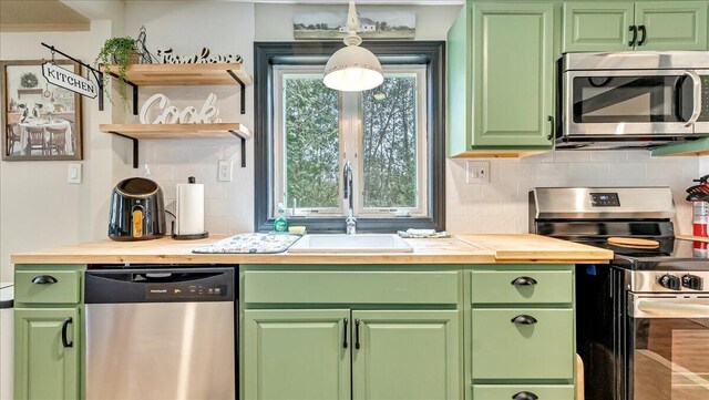 109 Silver Ln, Cresco, PA 18326 - kitchen featuring stainless steel appliances, a sink, butcher block counters, tasteful backsplash, and green cabinetry
