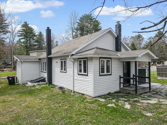 109 Silver Ln, Cresco, PA 18326 - rear view of house featuring a chimney, a lawn, and a shingled roof