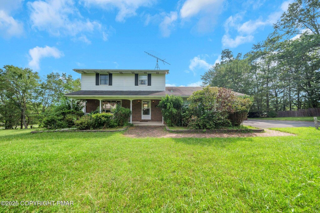 115 Heights Ct, Stroudsburg, PA 18360 - traditional-style home featuring brick siding and a porch
