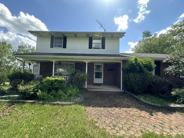115 Heights Ct, Stroudsburg, PA 18360 - traditional-style home featuring brick siding and a porch