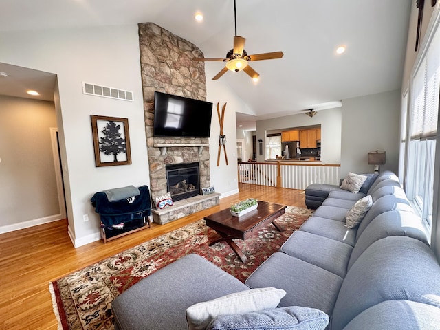 living area with a ceiling fan, visible vents, plenty of natural light, and light wood-style flooring