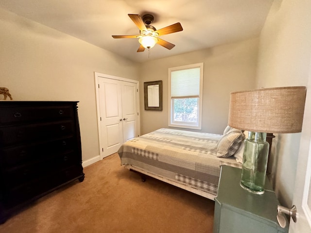 bedroom featuring carpet floors, ceiling fan, baseboards, and a closet