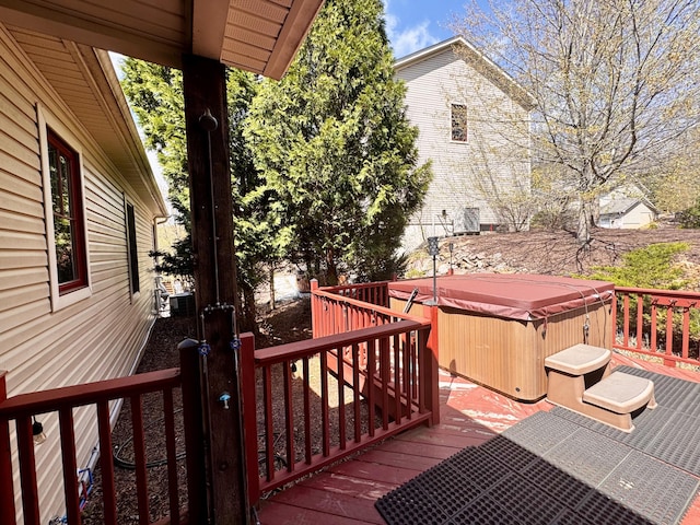 wooden deck featuring a hot tub