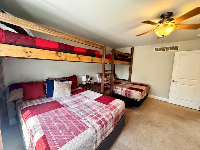 bedroom with carpet floors, ceiling fan, baseboards, and visible vents