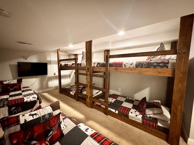 carpeted bedroom featuring visible vents and baseboards