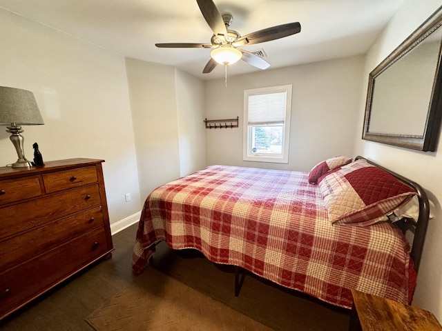 bedroom with baseboards, a ceiling fan, and dark carpet