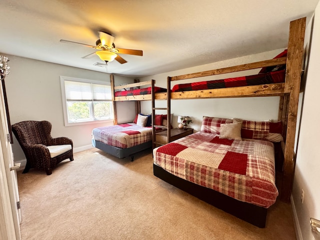 bedroom featuring carpet floors, a ceiling fan, baseboards, and visible vents
