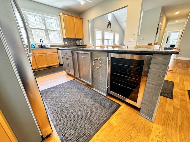 kitchen featuring wine cooler, light wood-style floors, and a healthy amount of sunlight