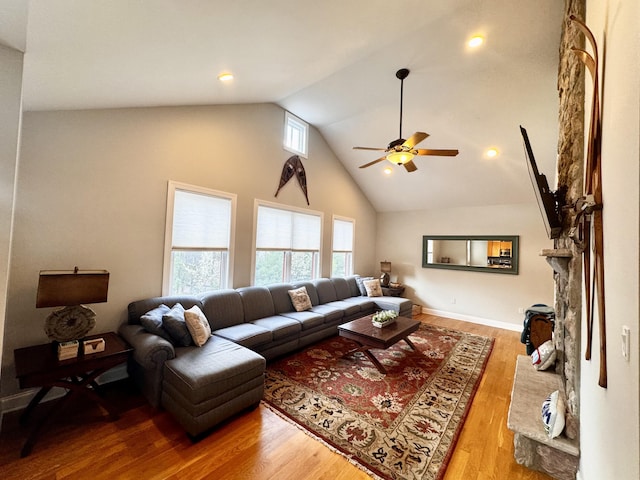 living area featuring ceiling fan, high vaulted ceiling, and light wood-type flooring