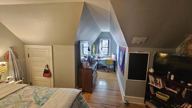 455 Laurel Pine Rd, Cresco, PA 18326 - bedroom featuring wood finished floors, baseboards, lofted ceiling, and an office area