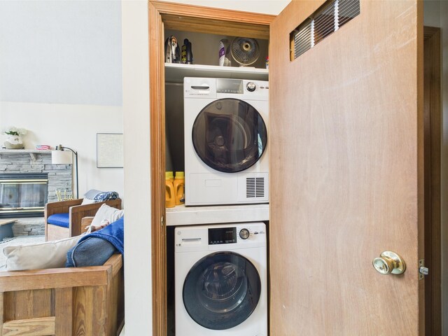 199 Wyomissing Dr, Pocono Lake, PA 18347 - washroom with stacked washing machine and dryer and a stone fireplace
