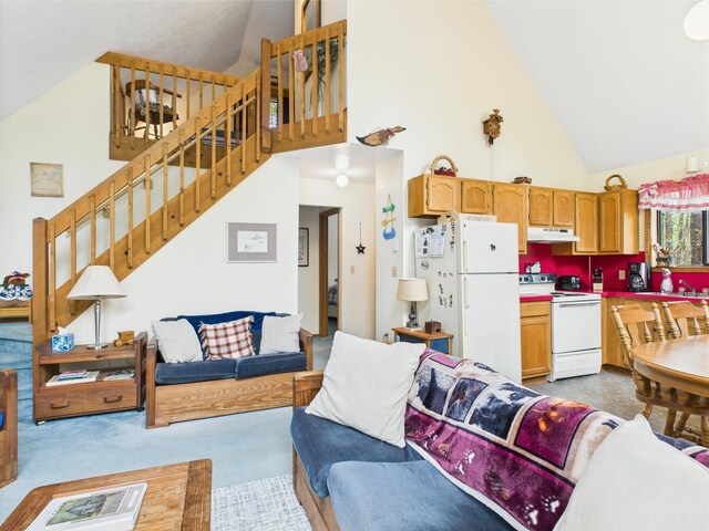 199 Wyomissing Dr, Pocono Lake, PA 18347 - living room with high vaulted ceiling, stairs, and light carpet