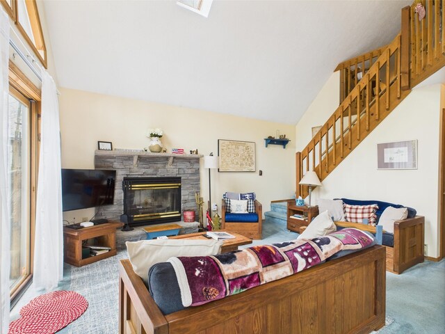 199 Wyomissing Dr, Pocono Lake, PA 18347 - carpeted living area with a stone fireplace, vaulted ceiling, and stairway