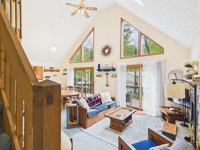 199 Wyomissing Dr, Pocono Lake, PA 18347 - carpeted living room featuring high vaulted ceiling, a ceiling fan, and a skylight