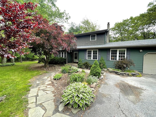 719 Homestead Ave, Effort, PA 18330 - traditional-style home featuring a chimney, asphalt driveway, a front yard, and an attached garage