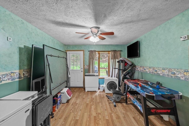 2726 Pocono Cir, Bartonsville, PA 18321 - exercise area with light wood-type flooring, ceiling fan, and a textured ceiling