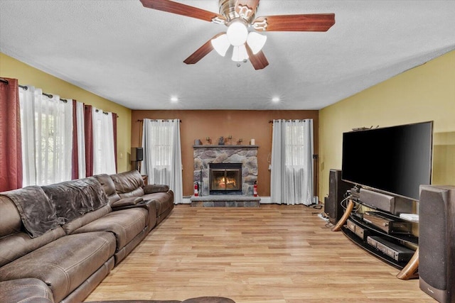 2726 Pocono Cir, Bartonsville, PA 18321 - living area with light wood finished floors, a ceiling fan, a fireplace, recessed lighting, and a textured ceiling