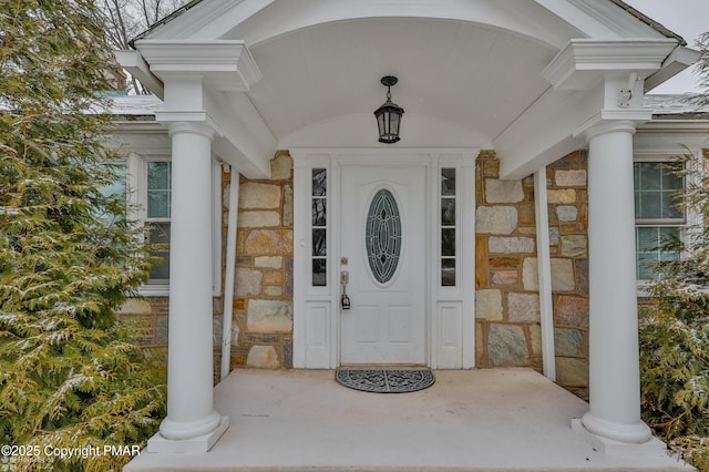 entrance to property featuring stone siding