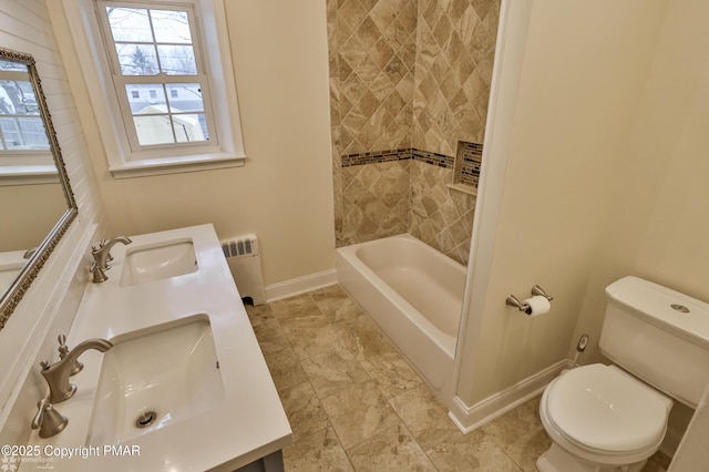 full bathroom featuring toilet, radiator, baseboards, and a sink