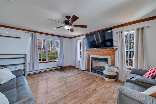 living area featuring ornamental molding, wood finished floors, baseboard heating, and a wall mounted AC